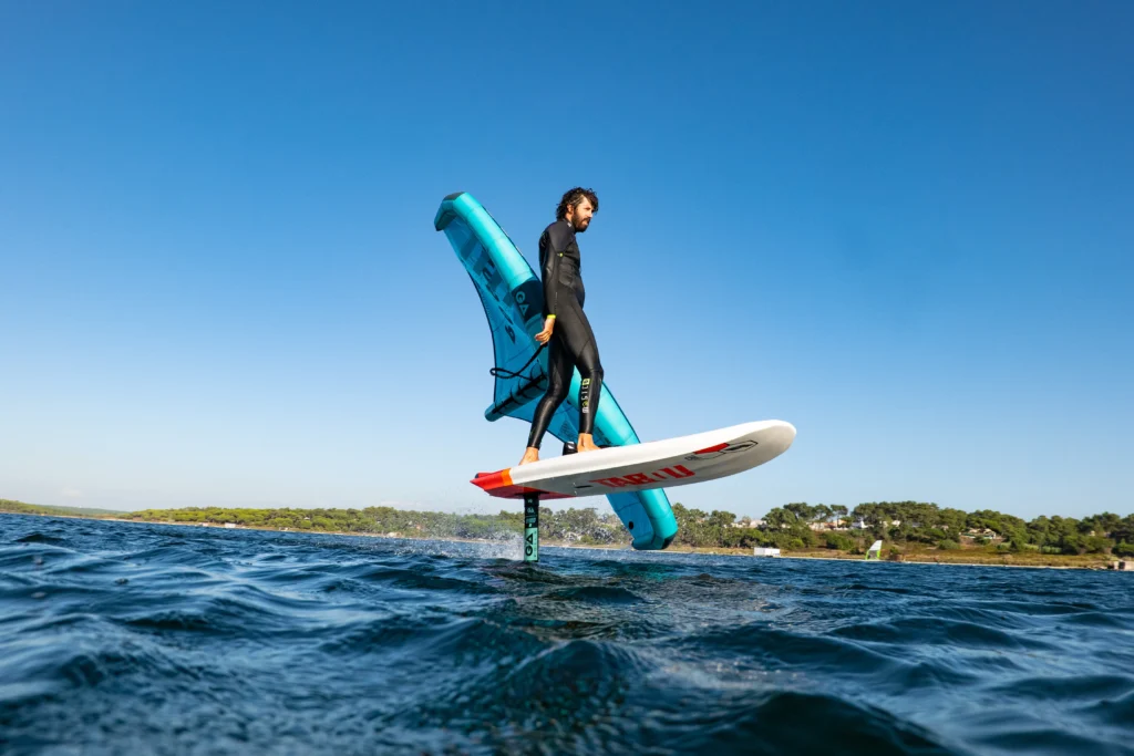 Rider flying over water on a foil board in Lagoa de Albufeira